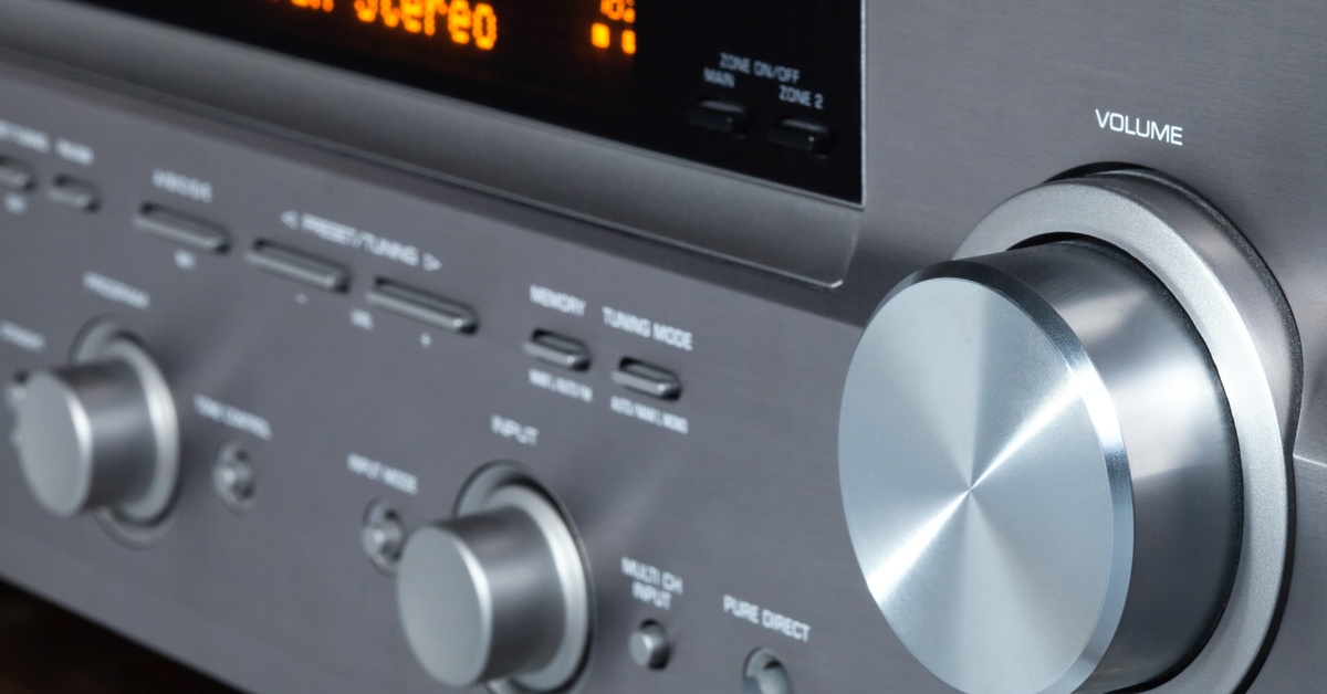 A close-up of a stereo sound receiver, focusing on its knobs and buttons, with the screen displaying "7 Channel Stereo."